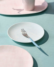 Mint plate with a fork on a surface