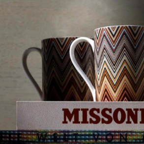 Two patterned mugs with a 'Missoni' label on a textured background